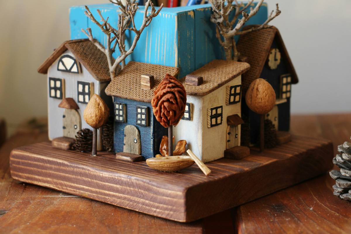 Antique-style handmade wooden keepsake boxes arranged on rustic linen with vintage trinkets spilling out