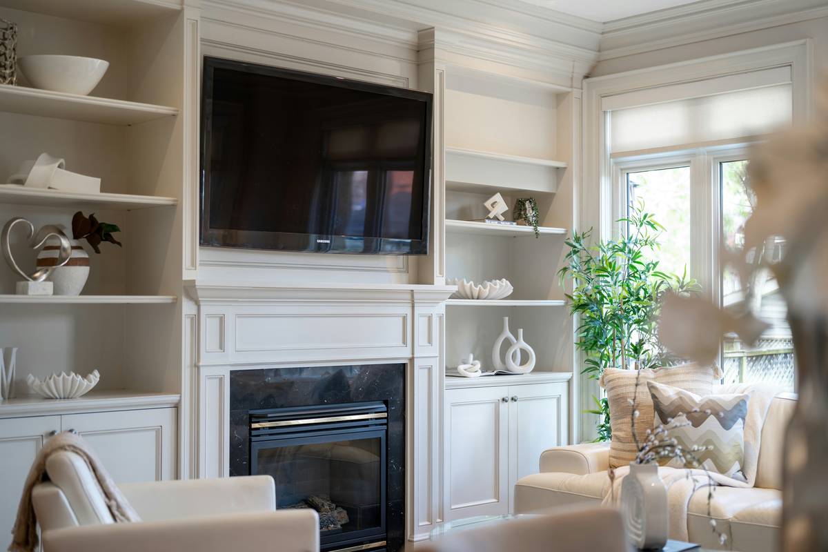 Stylish living room boxes arranged on a coffee table with remote controls and a book