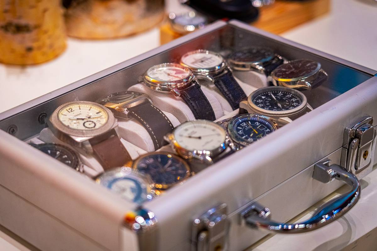 watch boxes for men displayed on a wooden dresser with leather exteriors and velvet lining